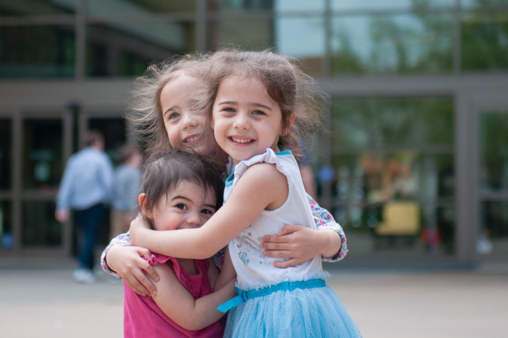 Three sisters hug during Jones Family Session with Tina Captures Photography