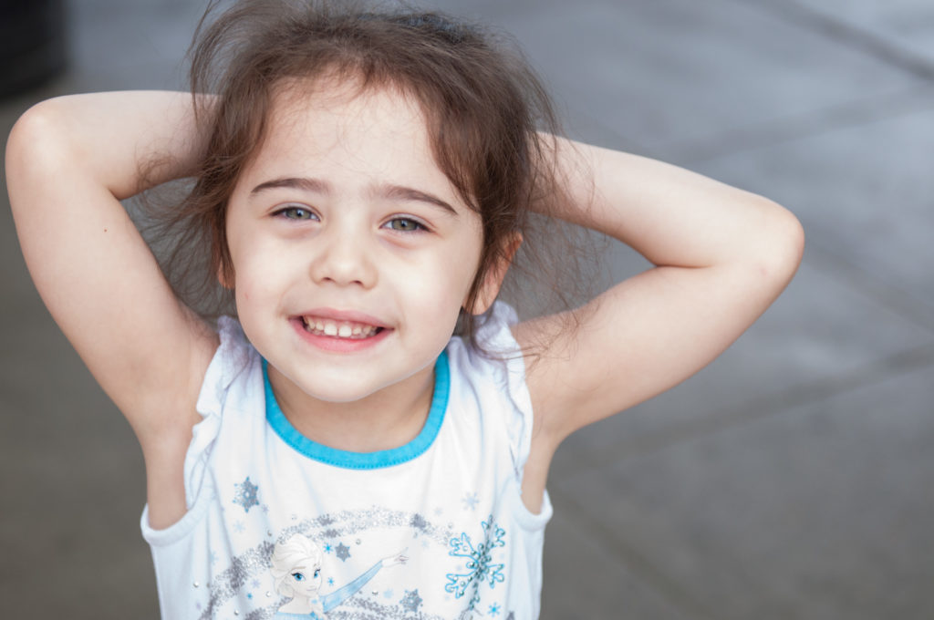 Jones Family Session daughter smiling while wearing a Frozen shirt