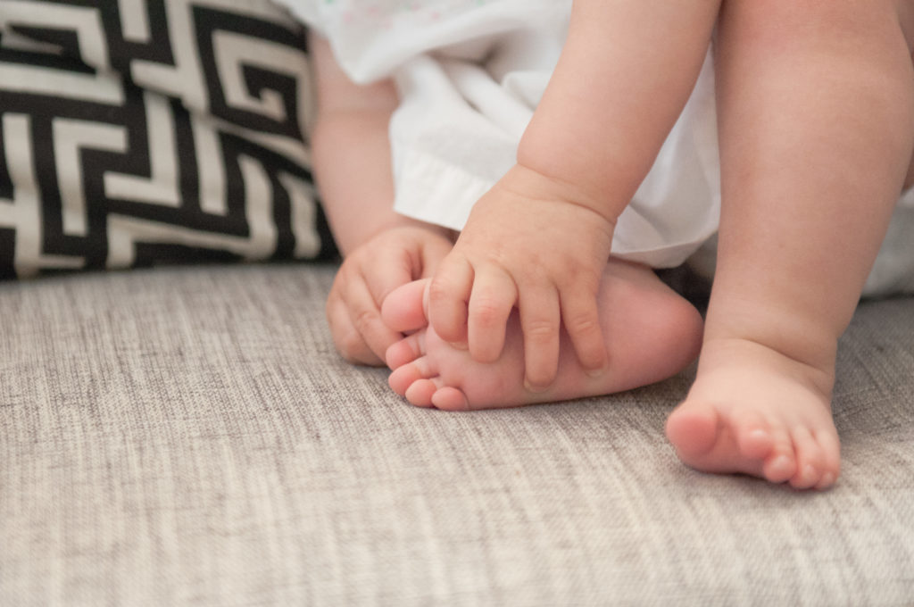 Close up of Emma grabbing her own foot