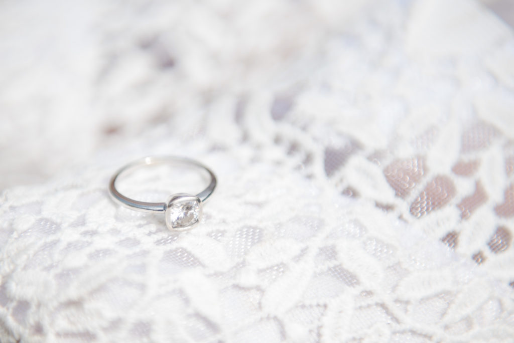 Jesse & Paige McEachran Homestead Winery outdoor wedding getting ready ring detail shot by Tina Captures Photography