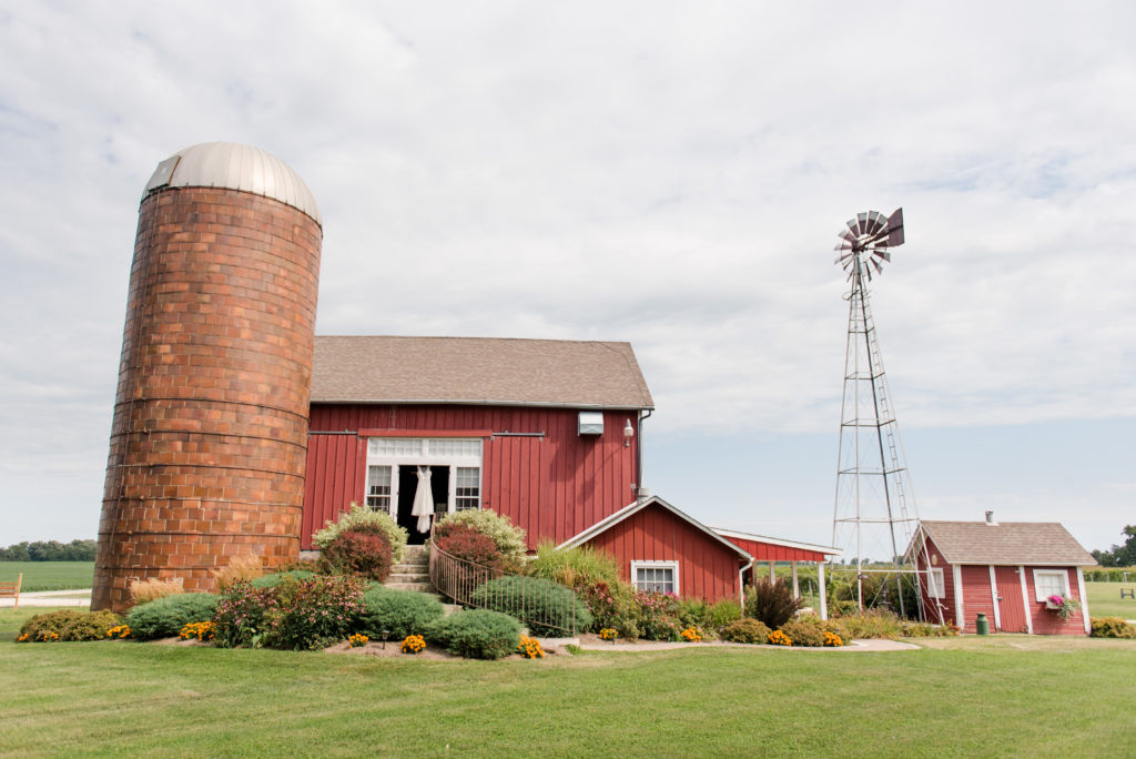 Jesse & Paige McEachran Homestead Winery outdoor wedding dress hanging in barn by Tina Captures Photography