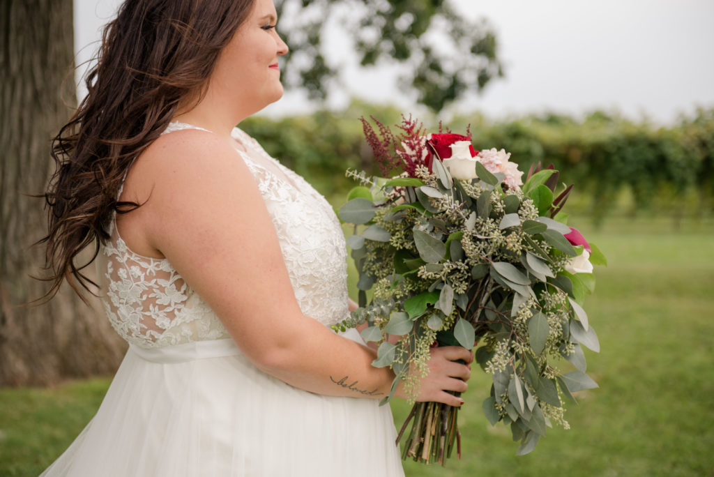 Jesse & Paige McEachran Homestead Winery outdoor wedding bride with boutique by Tina Captures Photography