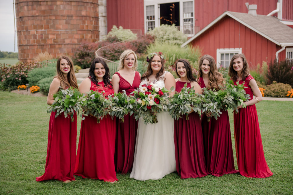 Bride with her bridal wedding party holding flower bouquets