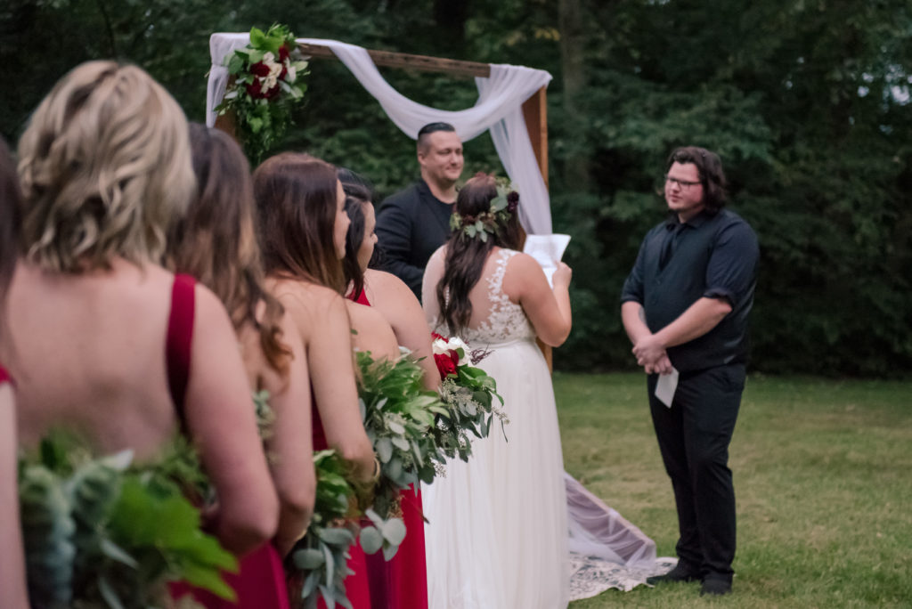 Jesse & Paige McEachran Homestead Winery outdoor wedding ceremony venue reading vows by Tina Captures Photography