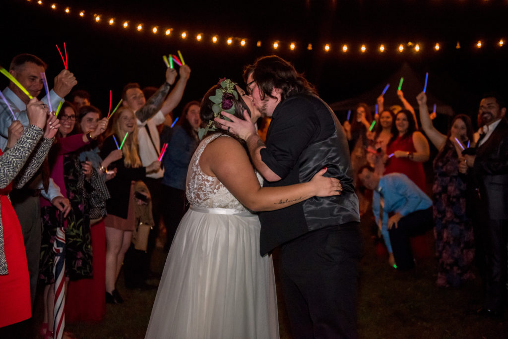 Jesse & Paige send off with glow sticks at dessert reception in the woods