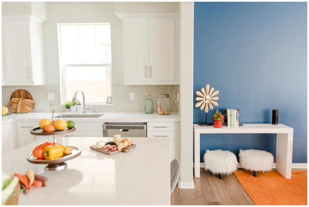 Kitchen transition to blue accented wall of dining room. Designed by McFadden & Grace. Tina Captures Photography.