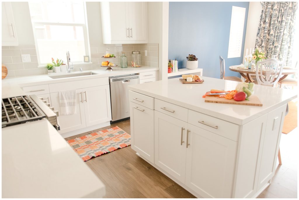 Light and bright spring home kitchen with island. Designed by McFadden & Grace. Tina Captures Photography.