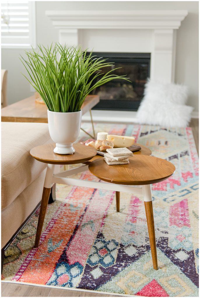 Living room three layered side table with green plant. Designed by McFadden & Grace. Tina Captures Photography.